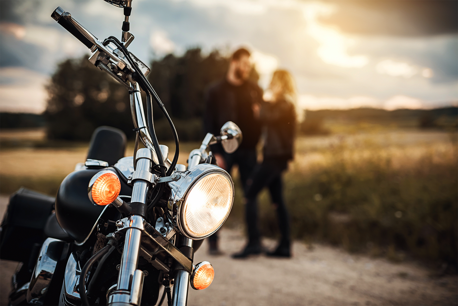 Couple with their motorcycle.