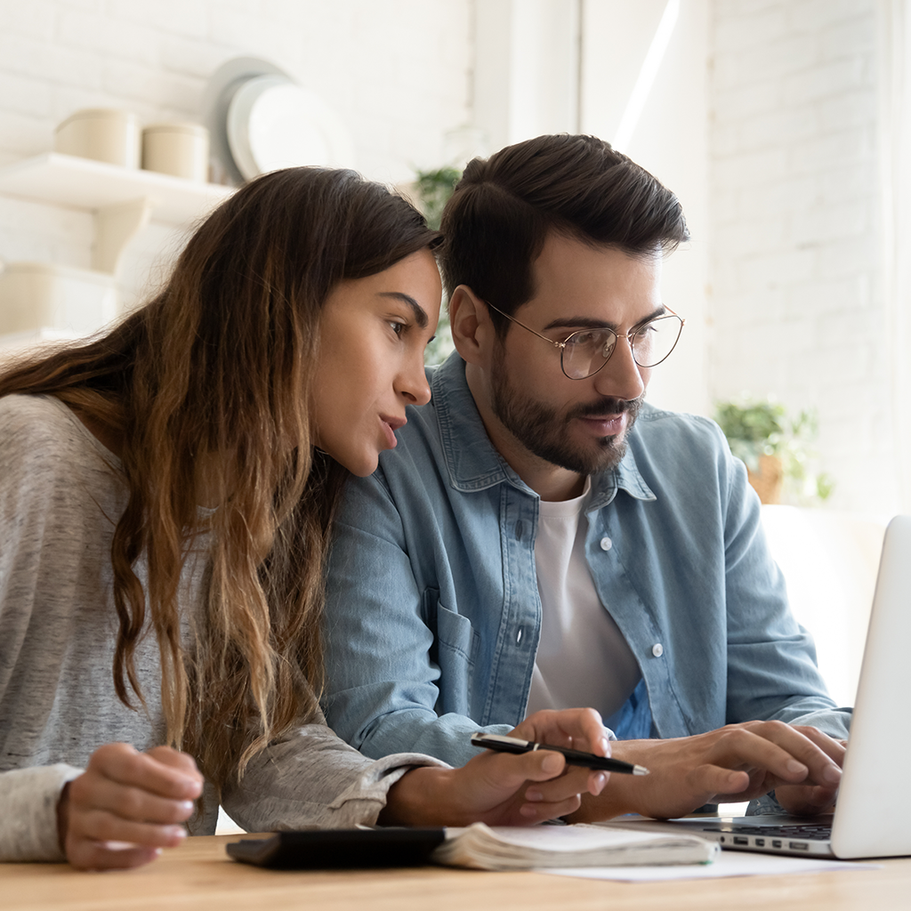 Couple looking at laptop computer.