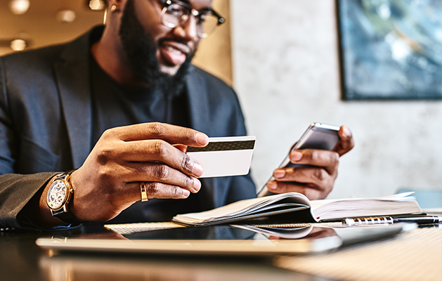 Man on phone with credit card.