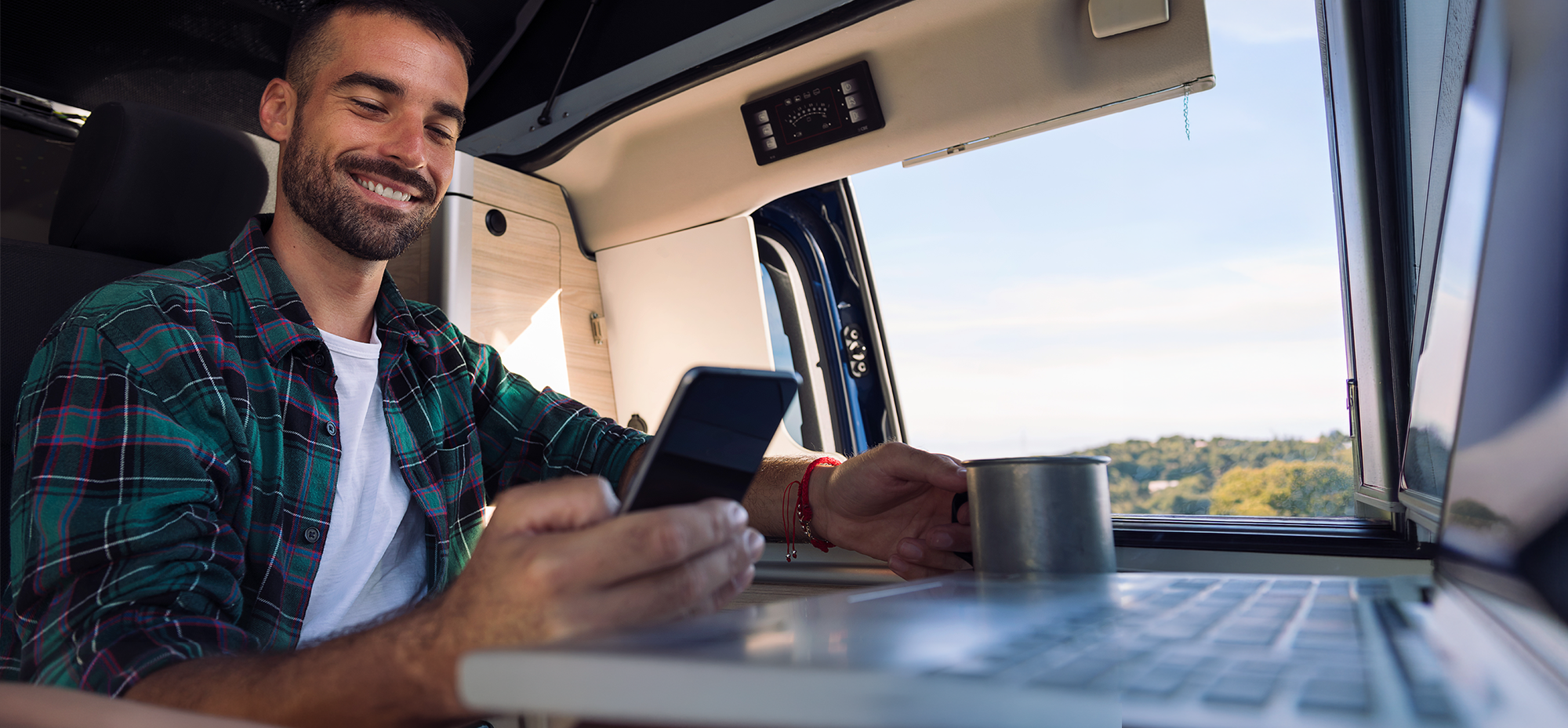 Man checking phone in an RV.