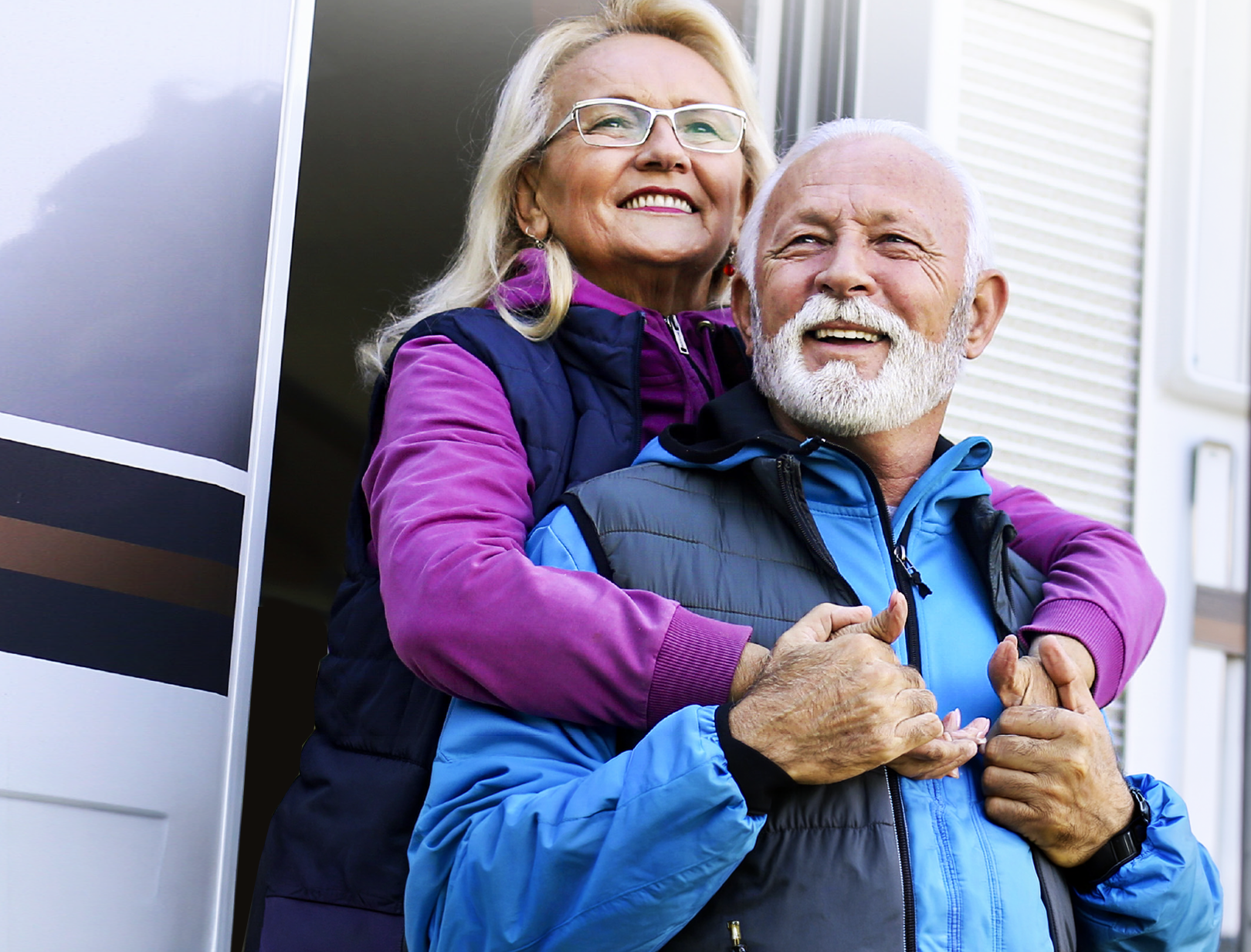 Couple standing in the door of an RV.