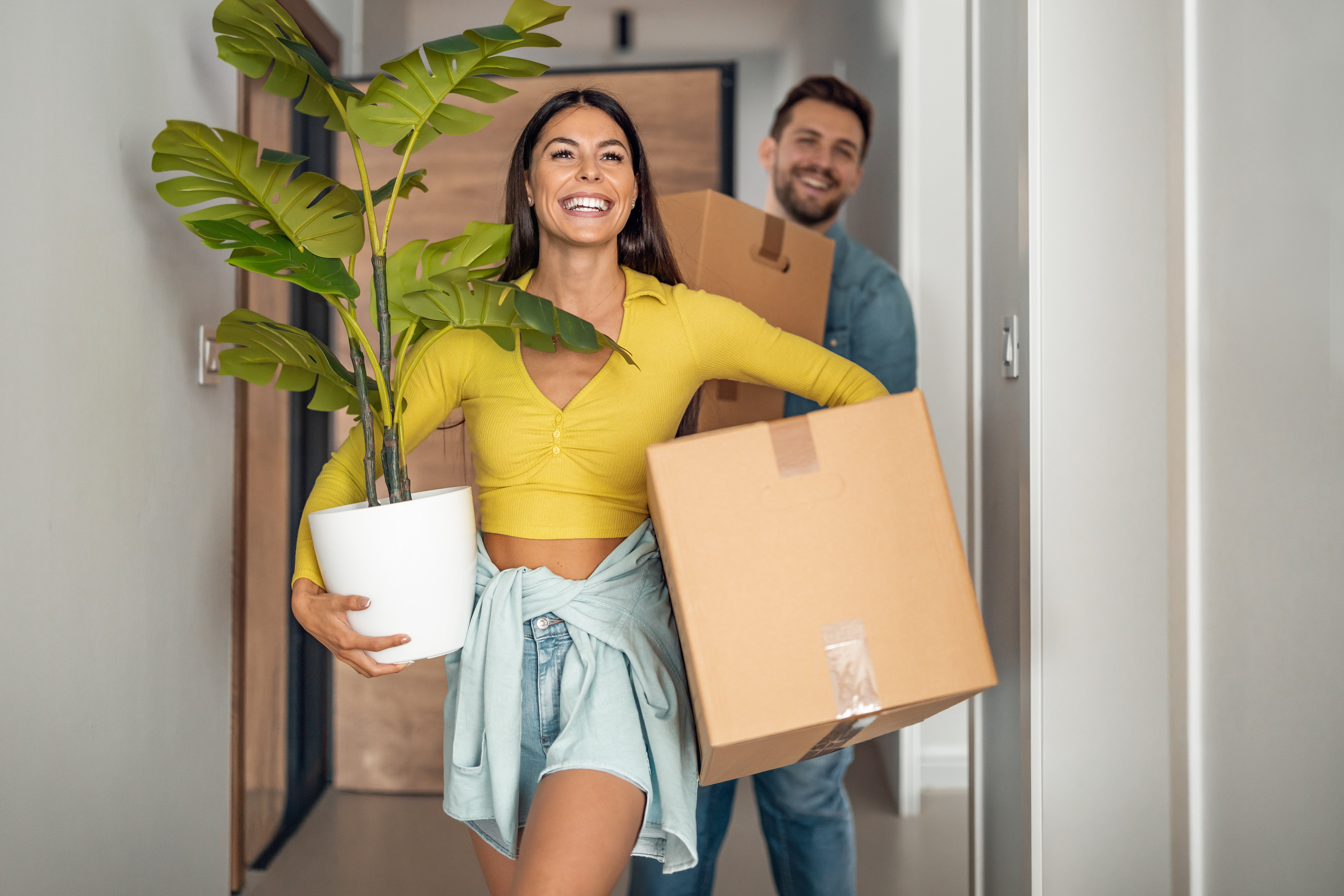 Two people moving into a new home.